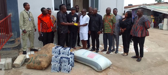 Dr Mensah (third from left) presenting the items to Nii Ampaw