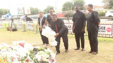 • Mr Samuel Mawusi Asafo laying a flower in memory of the victims
