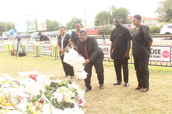 • Mr Samuel Mawusi Asafo laying a flower in memory of the victims