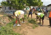 • Mr Anyetei (left) assisting in the clean-up exercise Photo: Victor A. Buxton
