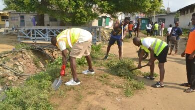 • Mr Anyetei (left) assisting in the clean-up exercise Photo: Victor A. Buxton