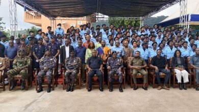 • Mr James Gunu (middle) with Officers and the Police Assistants