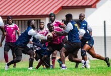 Captain of Skolars Riddick Alibah with the ball evading a tackle from players from Accra Panthers