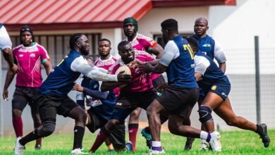 Captain of Skolars Riddick Alibah with the ball evading a tackle from players from Accra Panthers
