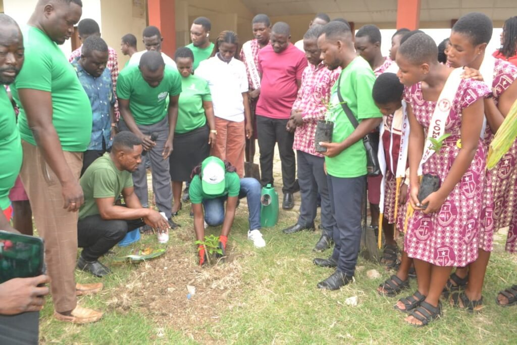 Ms Kanyoke (middle) planting a seedling during the exercise. With her is Mr Ebo Quansah Aduonum (third from right) and other dignitaries Photo: Victor A Buxton