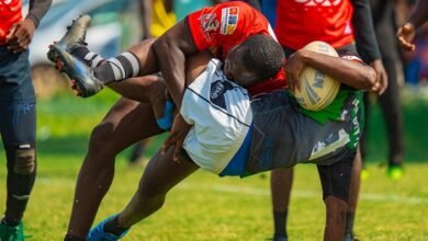 • Desmond Geotrah of Bulls tries to take the ball away from a Dragon's player