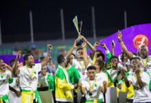 • Gold Stars players celebrating with the trophy