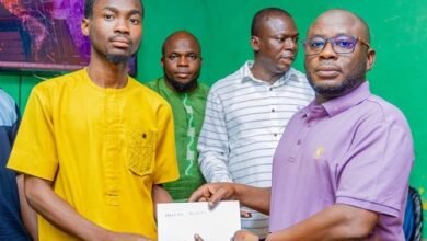 • Mr Abdul-Ganiu Sandoo presenting the receipt of the fees to a beneficiary