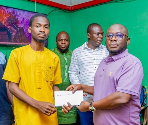 • Mr Abdul-Ganiu Sandoo presenting the receipt of the fees to a beneficiary