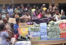 • Mr Mwinyelle handing over trhe items to Mrs Mable Amposah