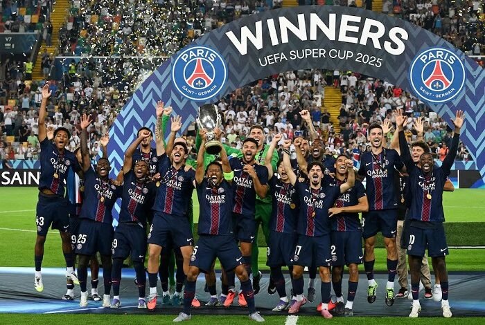 Marquinhos lifts the trophy as he celebrates with teammates after their victory