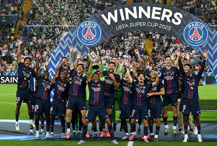 Marquinhos lifts the trophy as he celebrates with teammates after their victory