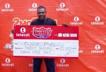 • Mr Owusu displaying his cheque