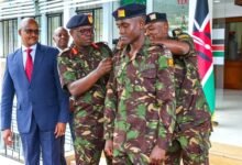 • Muchiri being decorated by Major General Kutto while General Kahariri (in suit) looks on