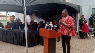 Dr Kuyon (inset) addressing staff and mourners at the ceremony