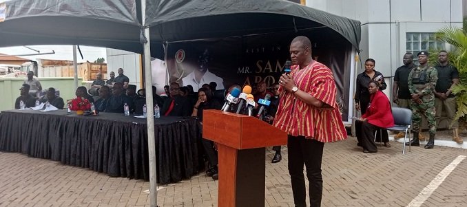 Dr Kuyon (inset) addressing staff and mourners at the ceremony