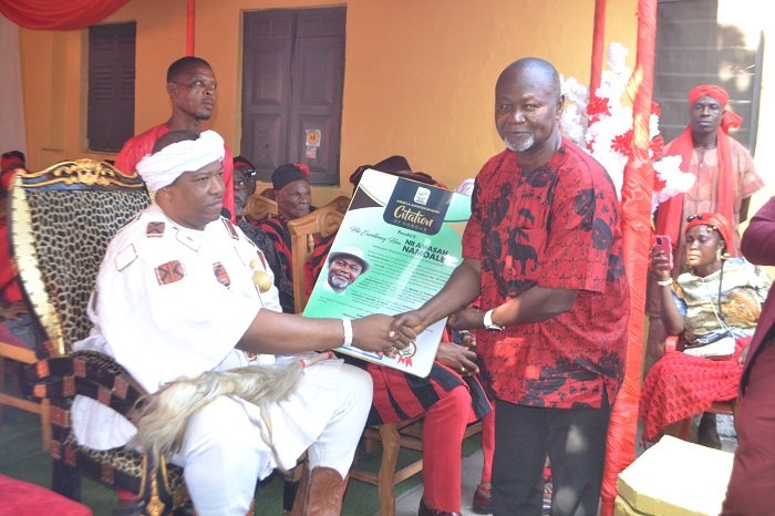 • Nii Kwade Okropong I, La Abese Adonten Mantse (seated) presenting a plaque to Mr Namoale during the programme Photo: Victor A. Buxton