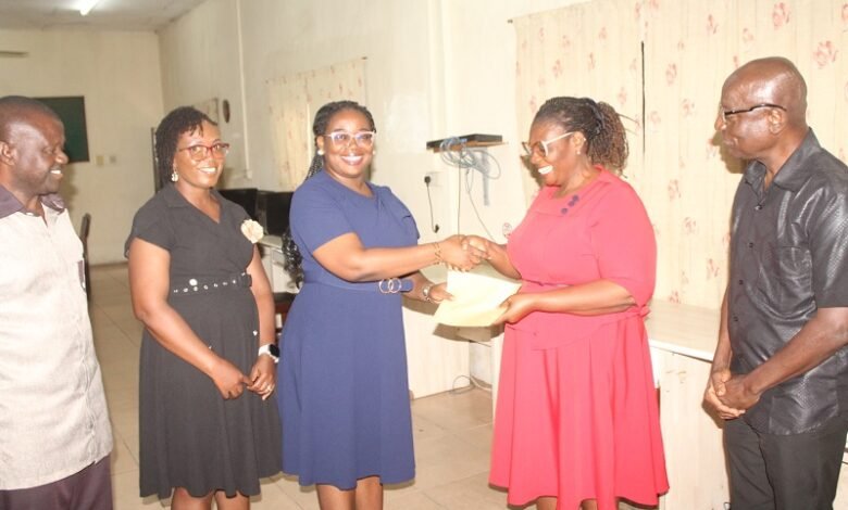 • Mrs Esther Ofori-Addo (second from right) receiving the cheque from Ms Esther Kumi. Present were both NIB and NTC staff