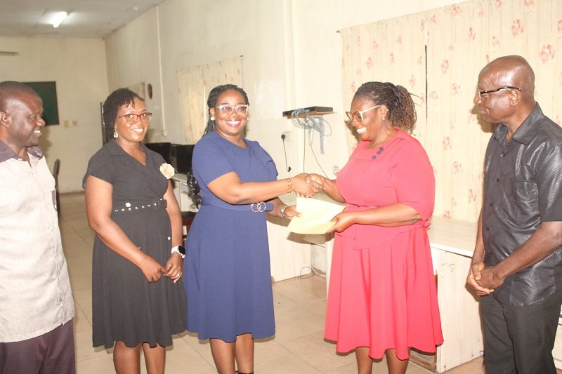 • Mrs Esther Ofori-Addo (second from right) receiving the cheque from Ms Esther Kumi. Present were both NIB and NTC staff