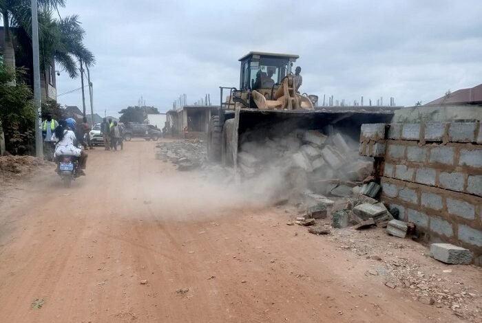 • A fence wall constructed on an access road being demolished