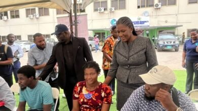 Ms Peprah (standing right) and Mr Benjamin Zigorsh-Nyakpenu interacting with some clients at the programme