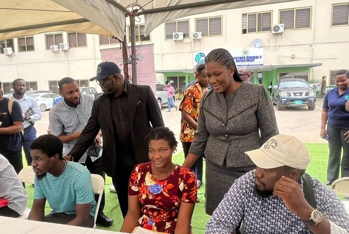 Ms Peprah (standing right) and Mr Benjamin Zigorsh-Nyakpenu interacting with some clients at the programme