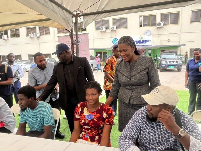 Ms Peprah (standing right) and Mr Benjamin Zigorsh-Nyakpenu interacting with some clients at the programme