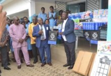 • Mr Quansah (second from left) presenting the items to Mr Aniagyei Photo: Victor A. Buxton