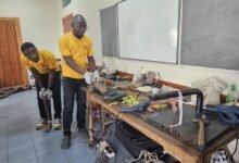 Technicians working on the prosthetic limbs. (Inset) Some of the prosthetic limps