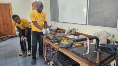 Technicians working on the prosthetic limbs. (Inset) Some of the prosthetic limps