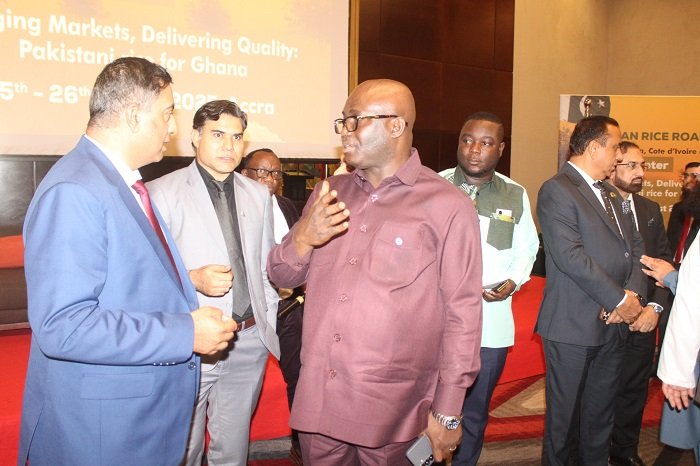 • Mr Eric Opoku (middle) interacting with Pakistan officials at the rice show programme. Photo. Ebo Gorman
