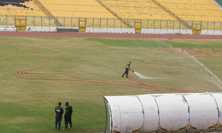 • Personnel of the GNFS watering the Baba Yara Stadium pitch