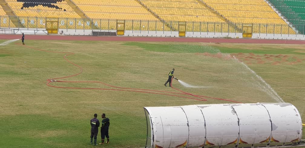 • Personnel of the GNFS watering the Baba Yara Stadium pitch