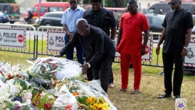 • SWAG President Kwabena Yeboah lays a wreath while some members look on