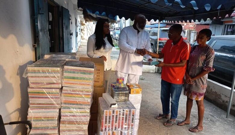 • Nii Abbey (second left) presenting the materials to Ataa Lartey