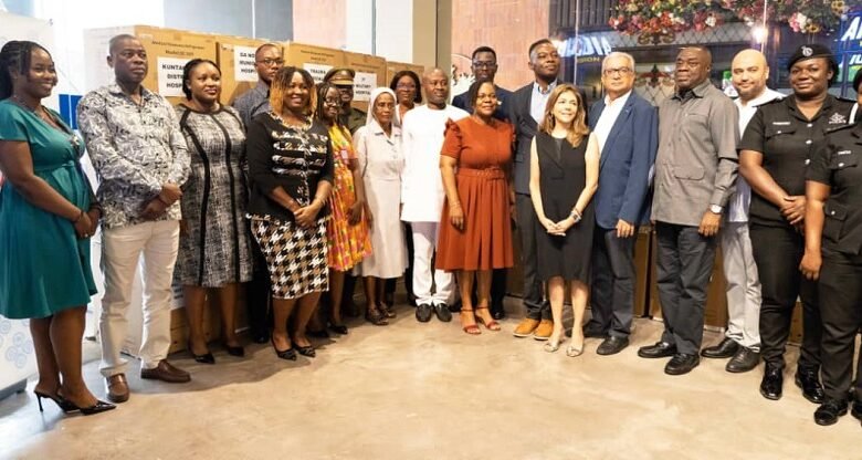 • The beneficiaries with MELCOM officials. (Inset)The medical items