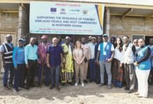 • Dignitaries infront of the yet to be completed refugee shelter in Zini, Upper West Region.