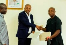 Mr Gamey(second from left) Prof Mawutor exchanging the signed documents