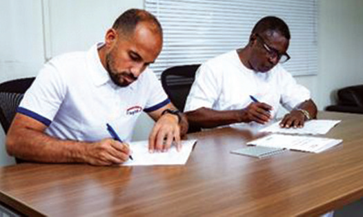 • Mr Fares Al-Ayadi and Mr Eric Adu-Dankwah signing the MoU