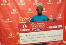 • Mr Salifu displaying his cheque