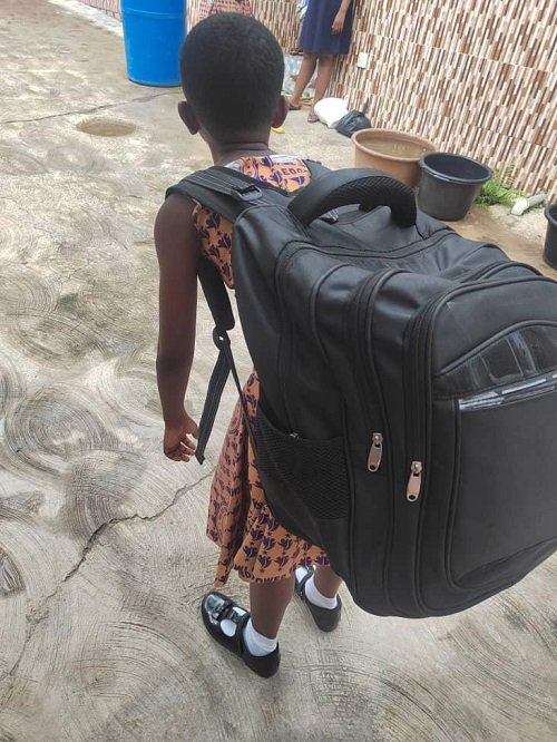 • A girl with a heavy school bag