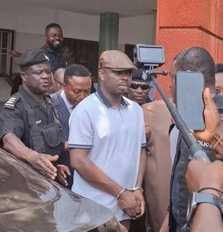 • Abronye, in handcuffs being escorted by the Police after court proceedings