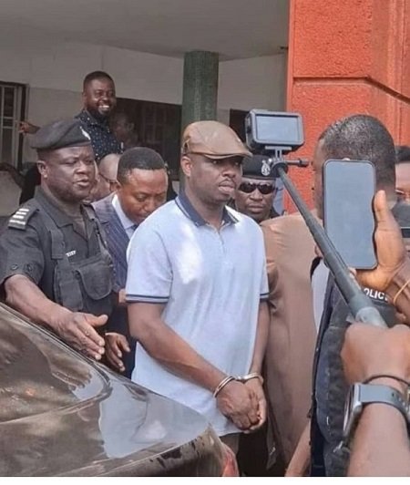 • Abronye, in handcuffs being escorted by the Police after court proceedings