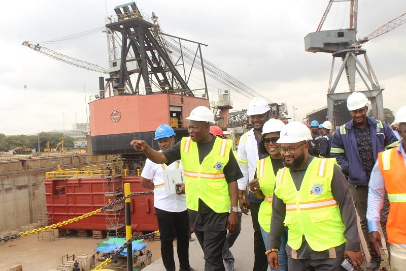 Alhaji Osman Sulemana (hand stretched), CEO Tema Shipyard, briefing Ms Dorcas Affo-Toffey (middle) during her visit to the Tema Shipyard comapany Photo: Ebo Gorman