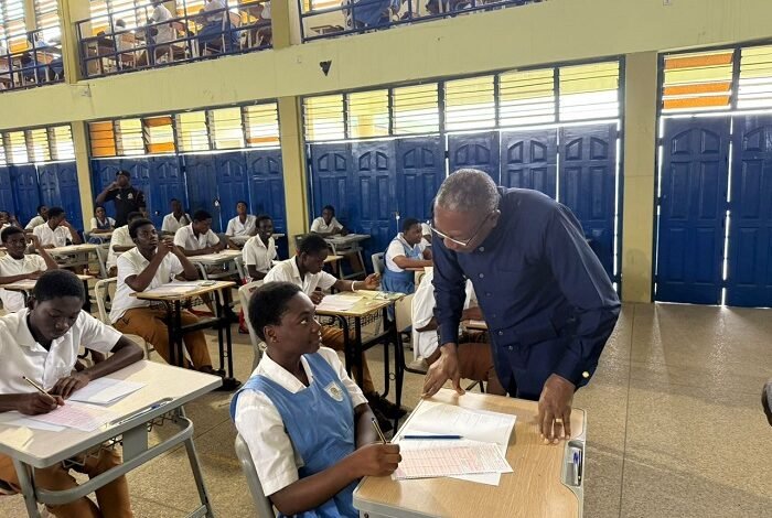 • Dr Apaak interacting with a student at an exams centre