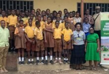 • Ataa Lartey and Mr Jerry Ahmed (extreme left) with some of the pupils and teachers of the academy and Parliamentary staff