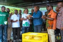 • President Mahama (third from right) being presented with a fowl during his visit to the farm