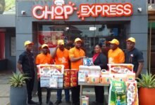 Mr Ugokwe (middle) presenting the items to Ms Allotey