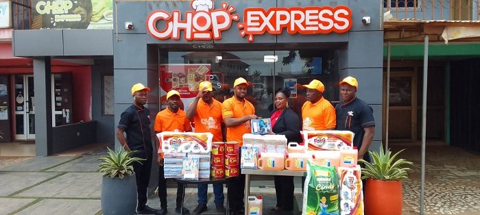 Mr Ugokwe (middle) presenting the items to Ms Allotey