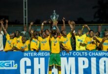 Captain of Ashanti, Agyei Duah, lift high the winner's trophy while his teammates celebrate